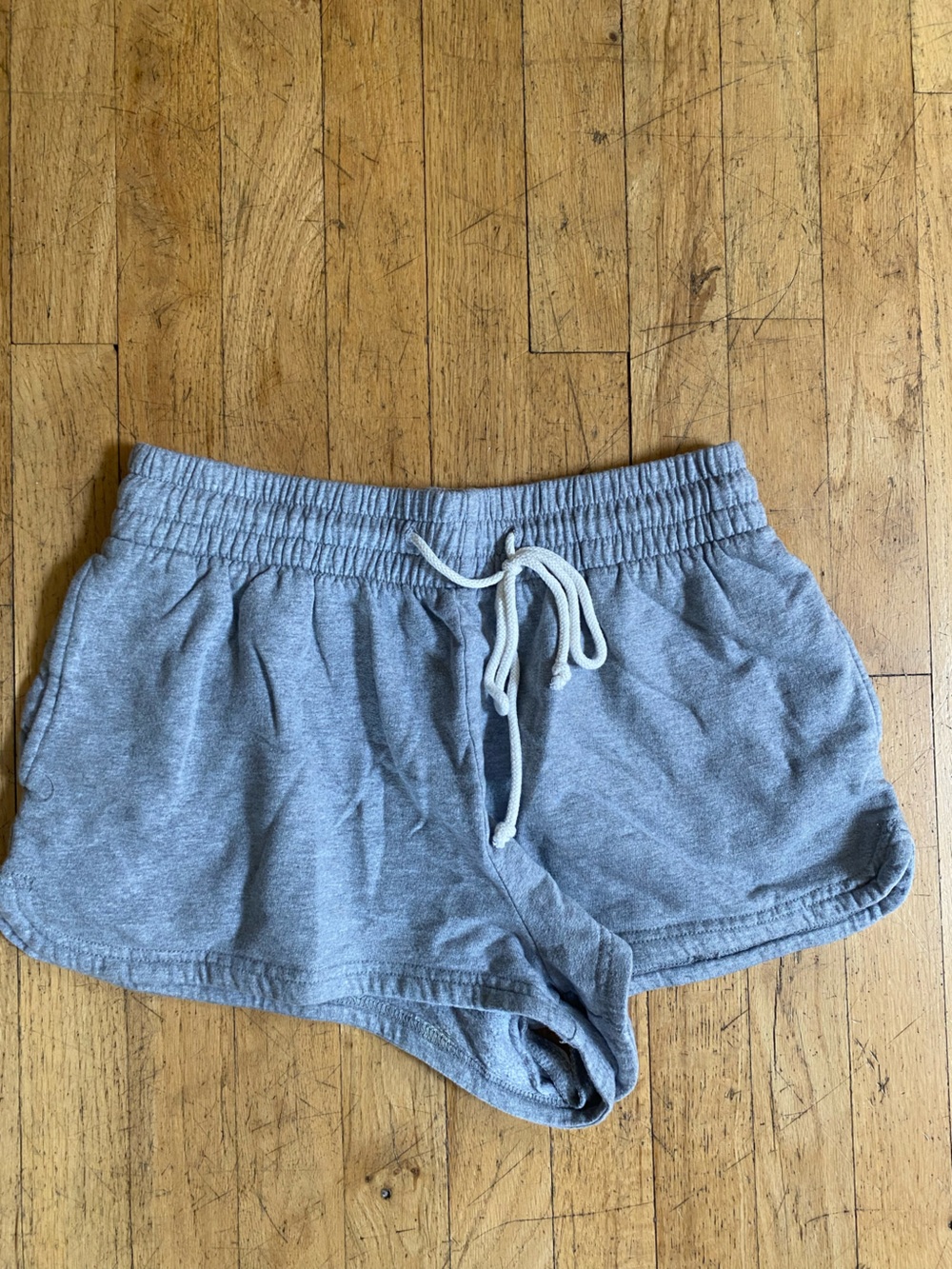 Out from under grey sweatshorts. Size medium